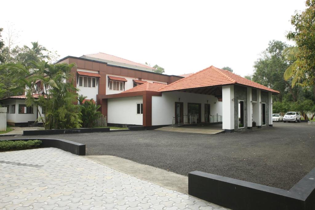 un estacionamiento frente a un edificio en Karapuram Village Resort & Spa, en Mararikulam