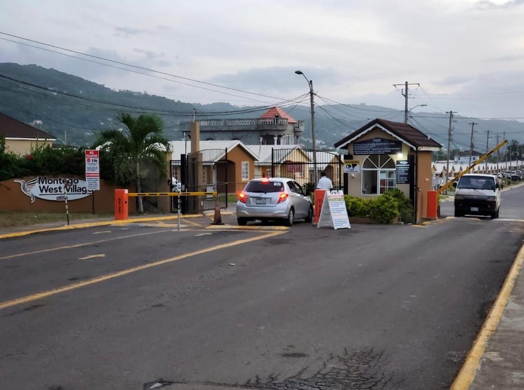 une voiture garée sur le côté d'une rue dans l'établissement The Rest Stop- Gated Community-24 Hrs Security, à Montego Bay