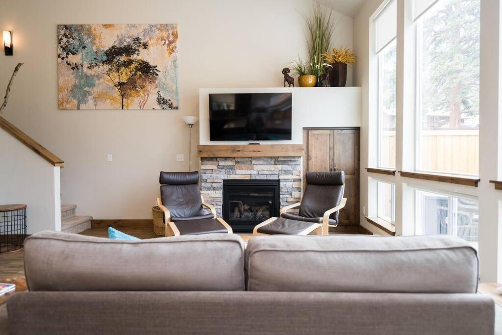 a living room with a couch and a fireplace at Close to RMNP, Estes,& Amenities in Estes Park