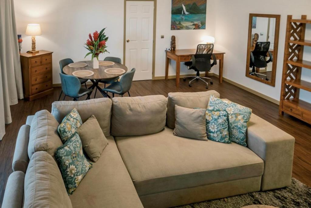 a living room with a couch and a table at Grand Large - Premium suite in Papeete