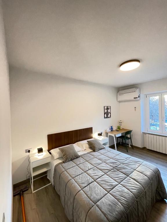 sypialnia z dużym łóżkiem i biurkiem w obiekcie Smart Silver Apartment Central w Bergamo