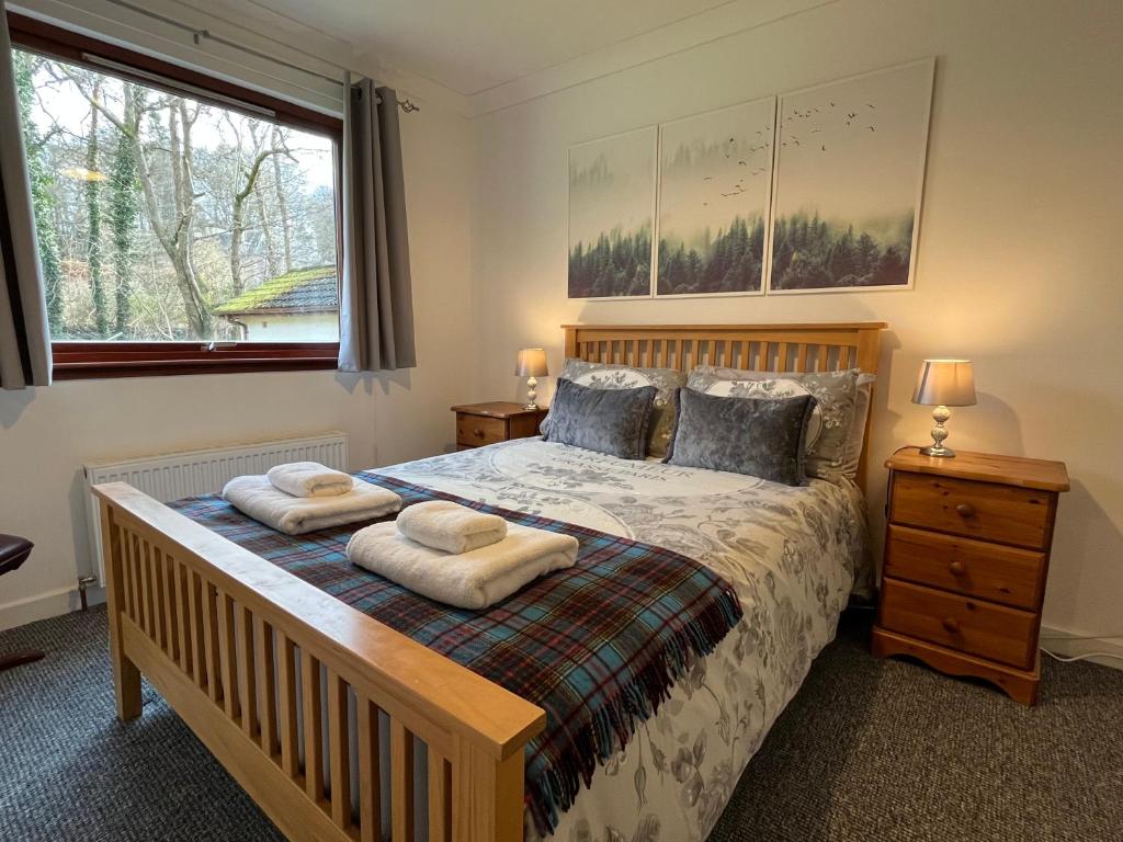 a bedroom with a bed with two towels on it at River house in Birnam