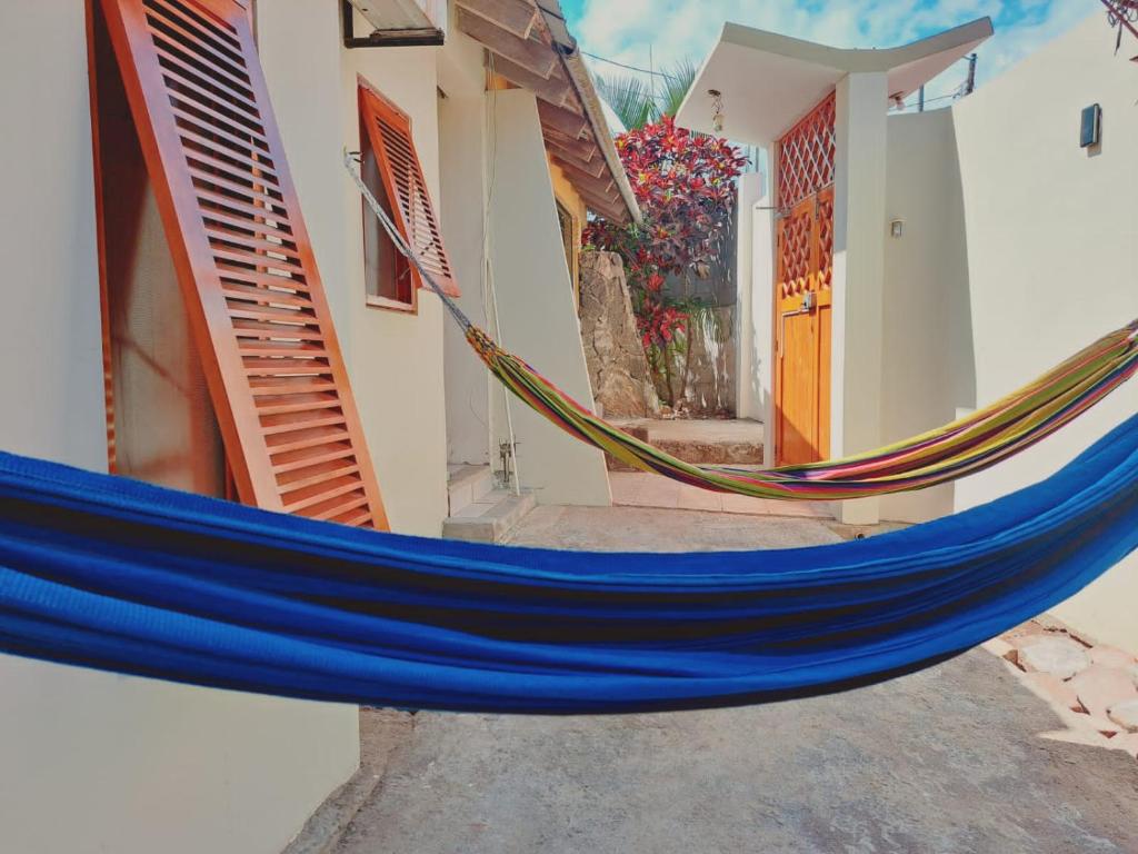 a blue hammock in front of a house at Casa Itabaca II in Puerto Ayora