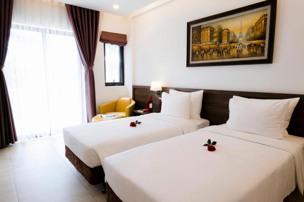 Postel nebo postele na pokoji v ubytování CEREJA Hotel & Resort Dalat