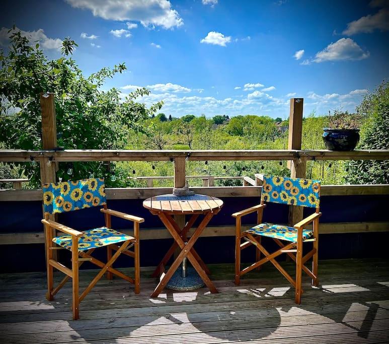 two chairs and a table on a porch at Countryside in the Town. in Harlescott