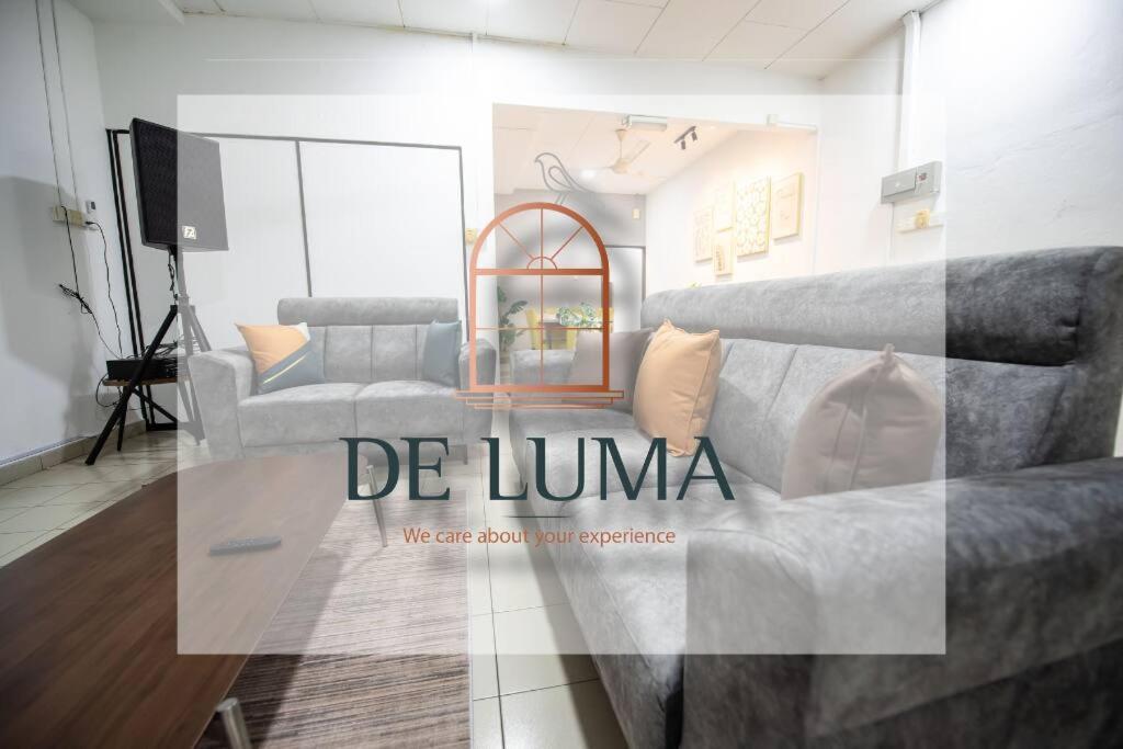 a living room with a couch and a tv at De Luma (The Rumah)@3bedroom (Sunflower) in Bukit Mertajam