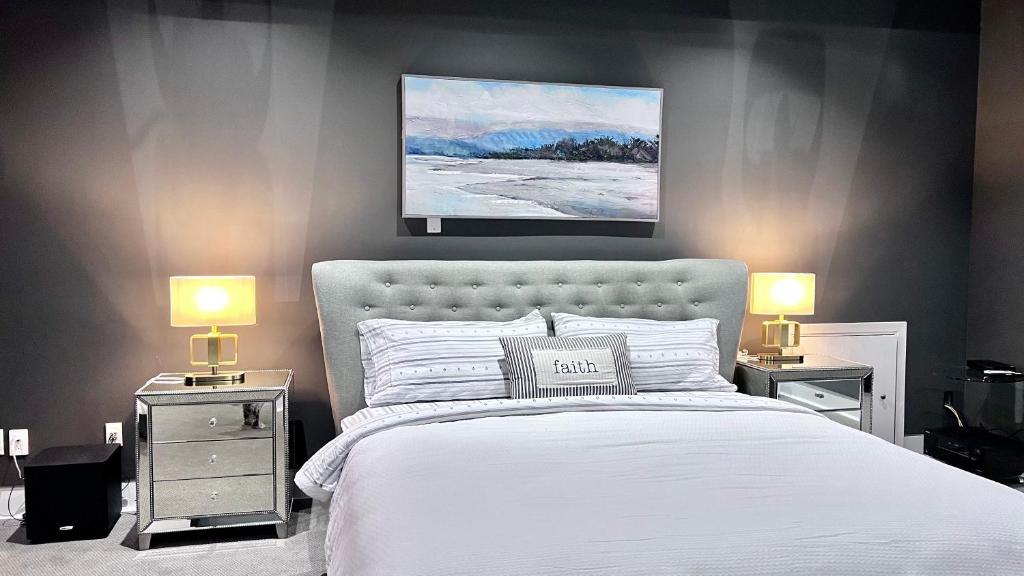 a bedroom with a white bed with two night stands at Kia Oceanview Property in West Vancouver