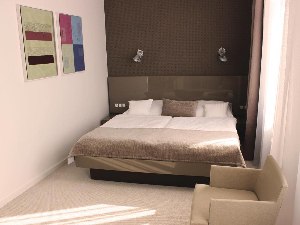 Postel nebo postele na pokoji v ubytování Hotel Lev