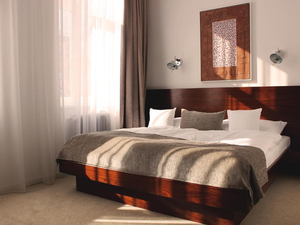 Postel nebo postele na pokoji v ubytování Hotel Lev
