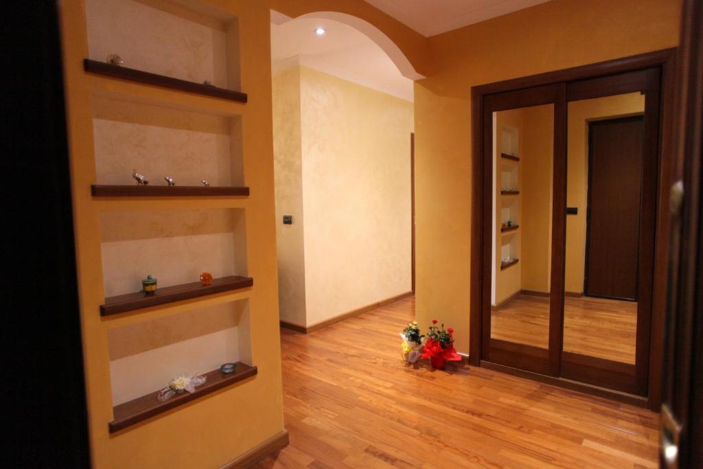 a hallway with a door leading to a room with shelves at B&B Margherita in Cosenza