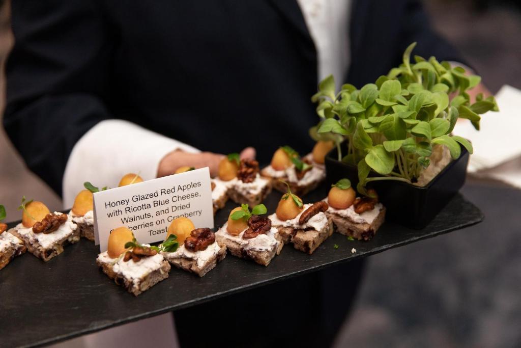 a person holding a tray of food on a plate at InterContinental Boston by IHG in Boston