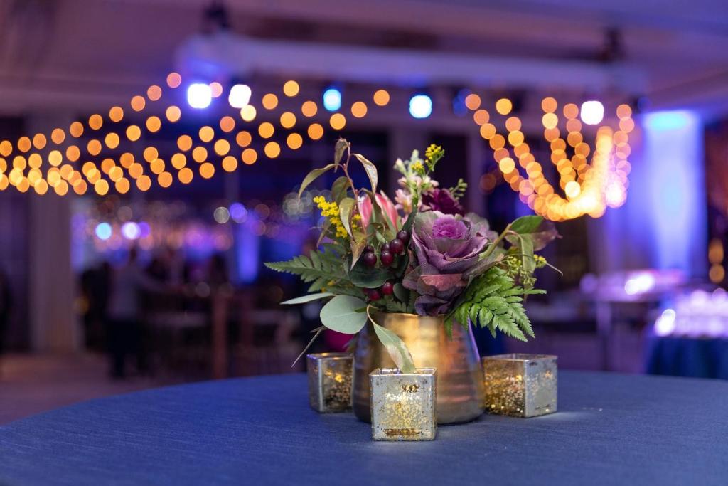 a vase of flowers sitting on a table with lights at InterContinental Boston by IHG in Boston