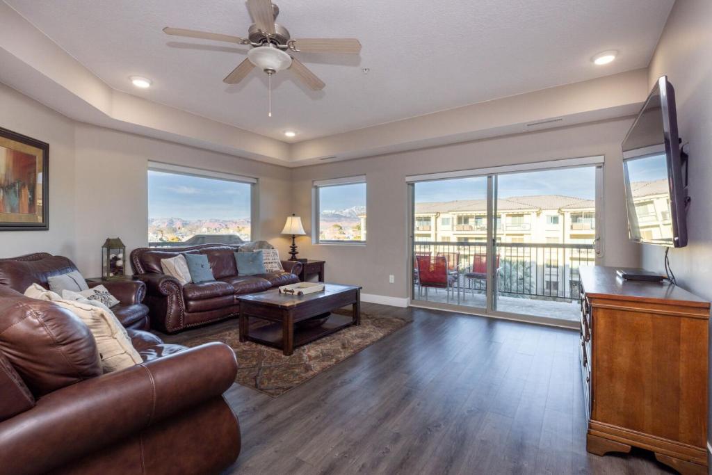 a living room with a couch and a table at W304-Mojave Skies Poolside 4 Bed Estancia Resort in St. George