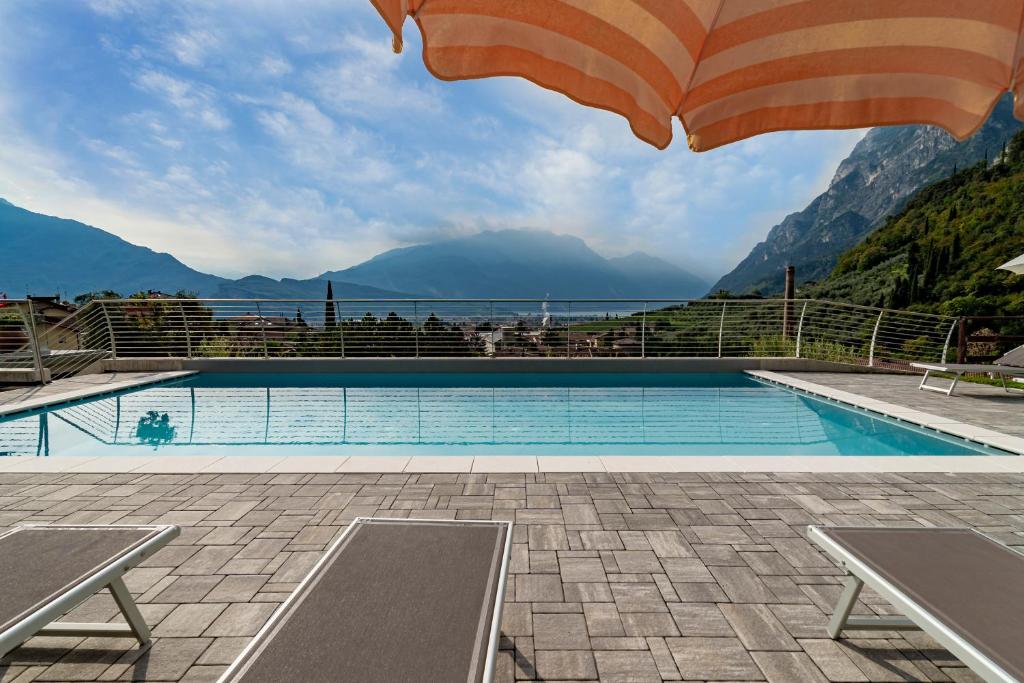 a swimming pool with a view of the mountains at GARNI' FOCI in Riva del Garda