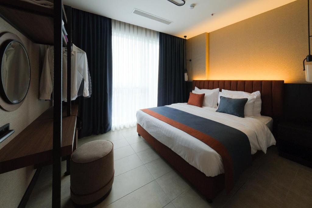 a bedroom with a large bed in a hotel room at The Kailyn Hotels&Suites Ataşehir in Istanbul