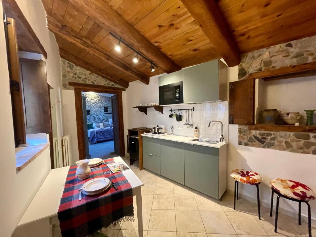 a kitchen with a table and a counter top at La Magara in Civita