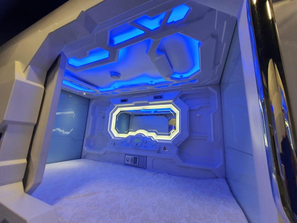 an inside view of an airplane with blue lights at My Capsule Hotel in Johor Bahru