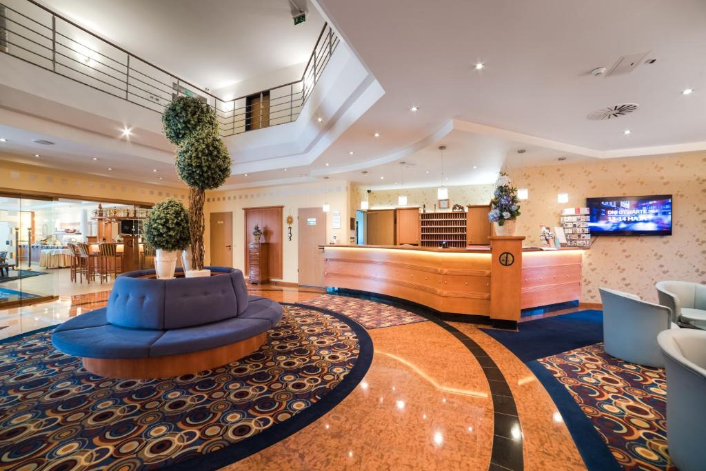 a lobby of a hotel with a reception desk at Hotel Partner in Warsaw