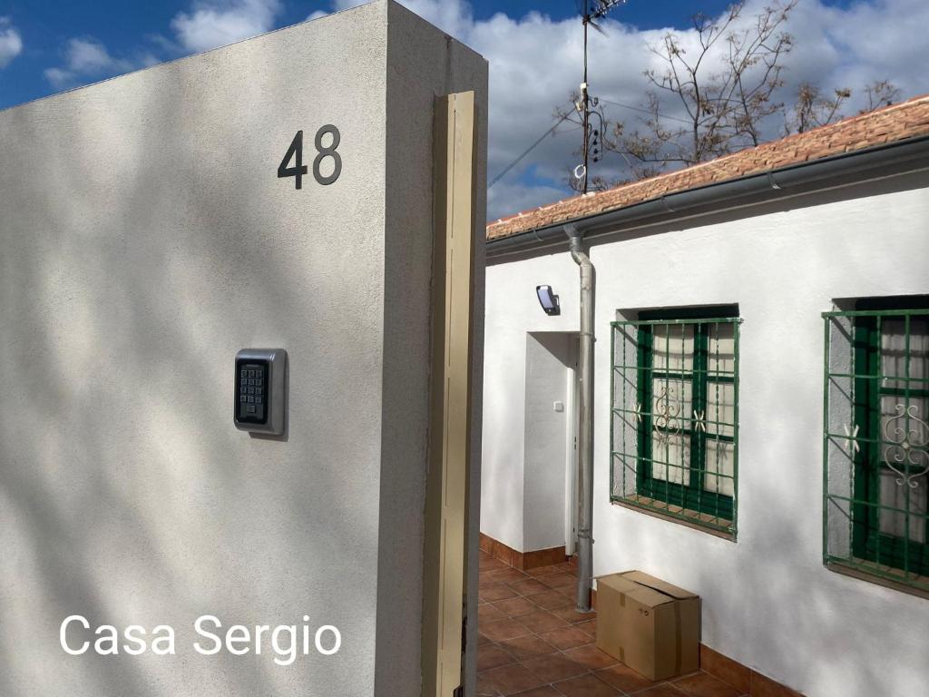 a white building with the number on it at Casa Sergio in Madrid