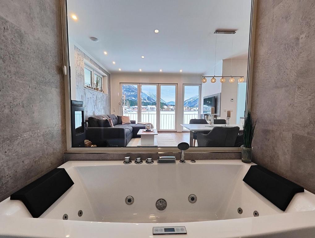 a large white bath tub in a living room at Unterschlupf in Ebensee