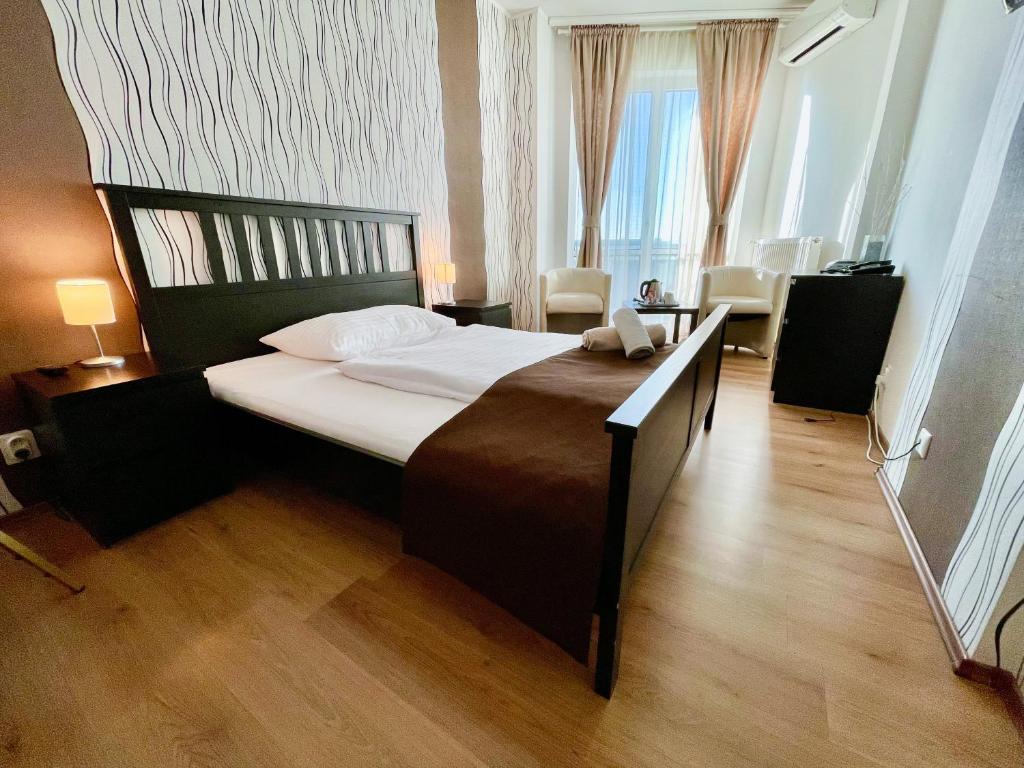 a bedroom with a large bed in a room at Hotel Modena in Bratislava