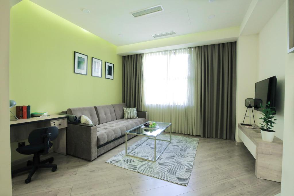 a living room with a couch and a table at Seine Apartment by Downtown Inn, City Center in Yerevan