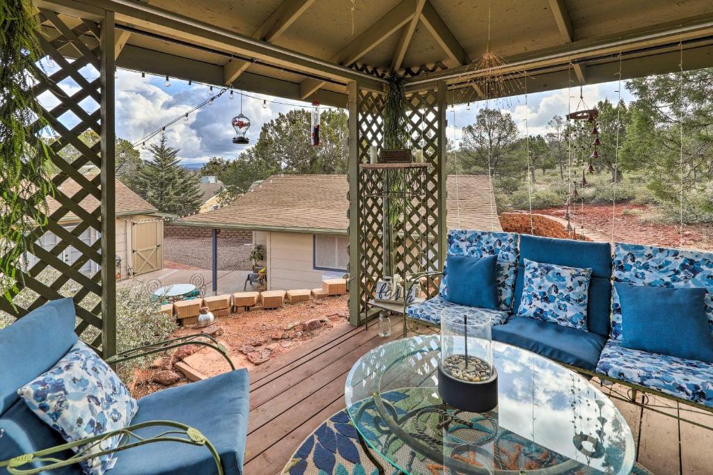 a screened in porch with a glass table and blue couches at Hike & Stargaze! Pet-Friendly Tonto Forest Studio in Payson