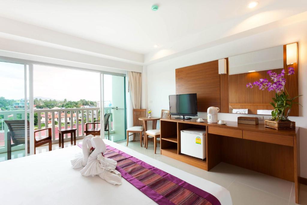 Postel nebo postele na pokoji v ubytování Rawai Princess Hotel
