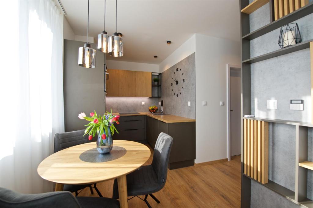a kitchen and dining room with a table and chairs at CITY PRESTIGE apartment Trencin in Trenčín