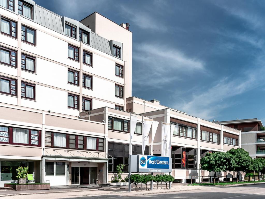 a large white building with a sign in front of it at Best Western Plaza Hotel Wels in Wels