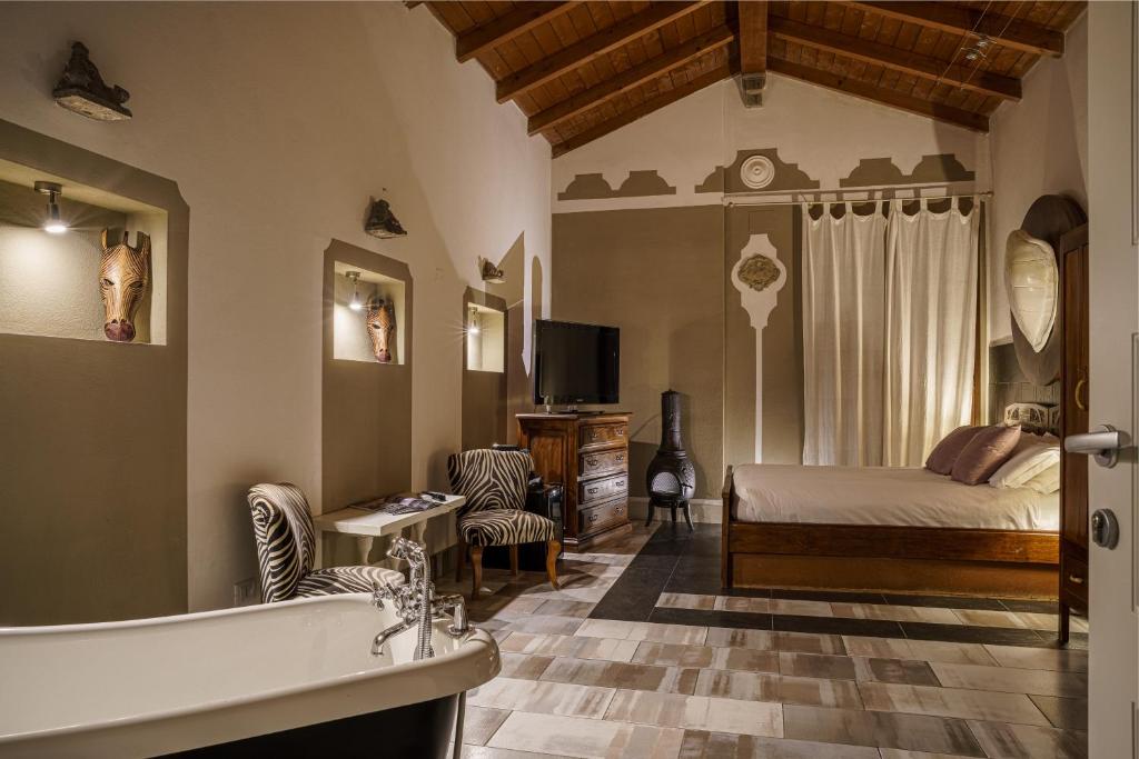 a bedroom with a bed and a tub in a room at Le Meraviglie di Alice in Cagliari