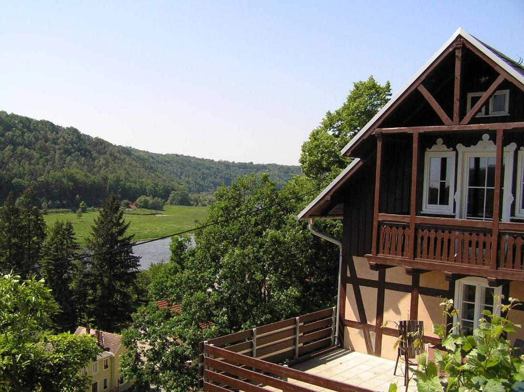 a house with a balcony with a view of a lake at Wehlener Landhaus in Stadt Wehlen, Sächsische Schweiz in Stadt Wehlen