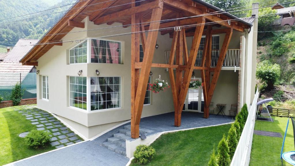 a house with a wooden roof at PENSIUNEA SUGAG in Şugag