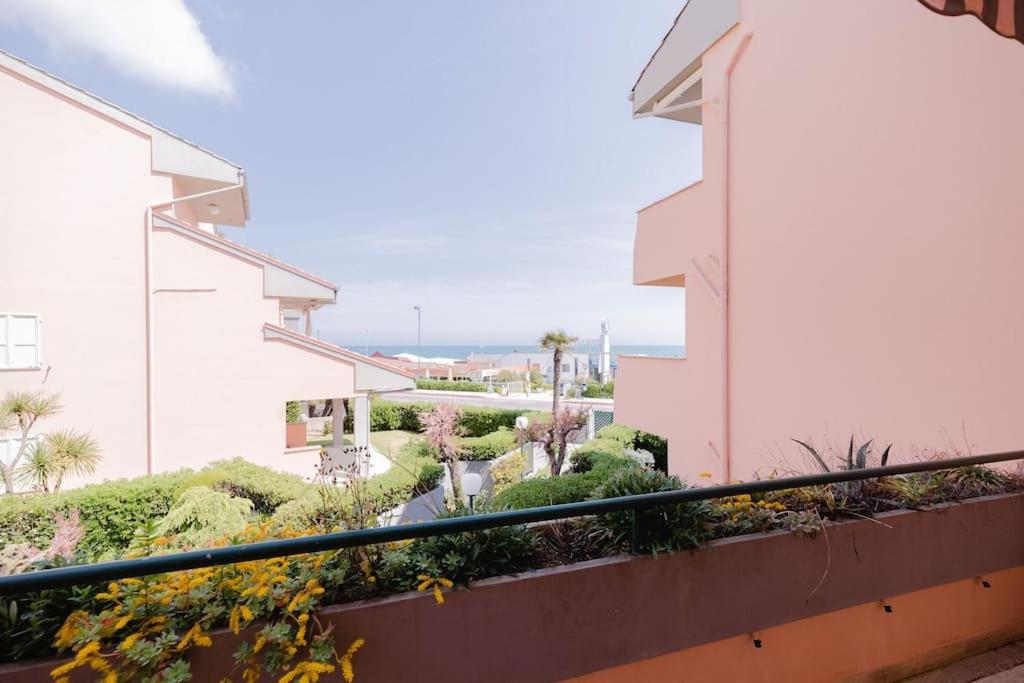 a balcony with a view of a courtyard at Appartamento a 20mt dal mare con piscina condominiale in Marcelli