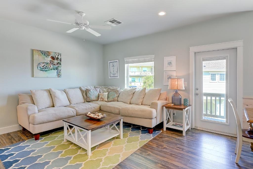 a living room with a couch and a table at Beachy Keen in Port Aransas