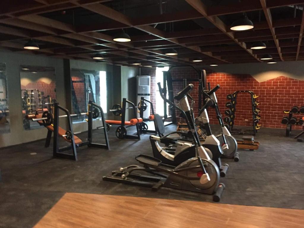 a gym with lots of treadmills and elliptical machines at Grand Residences Studio Unit - Walking Distance to IT Park in Cebu City