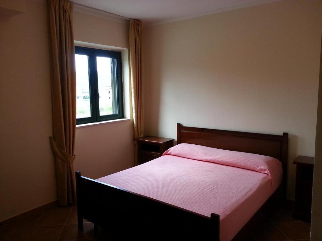 a bedroom with a bed and a window at San Nicola Il Sole in Albanella