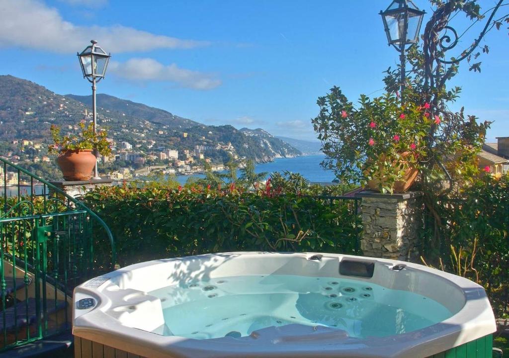 a jacuzzi tub with a view of the ocean at Villa Mares - sea view, free garage in Rapallo