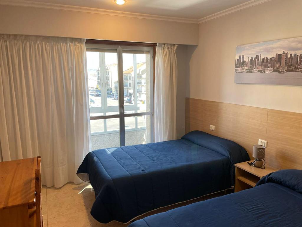 Posteľ alebo postele v izbe v ubytovaní HOSTAL CID