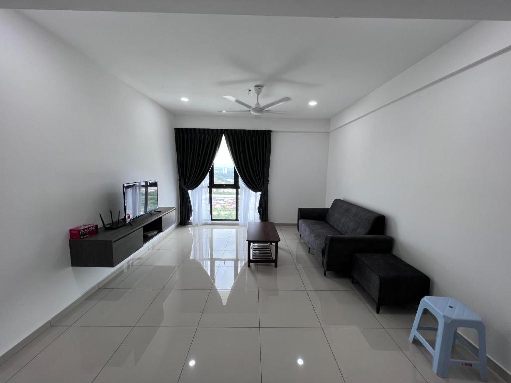 a living room with a couch and a tv at Menara Sentral at Juru Sentral in Bukit Mertajam