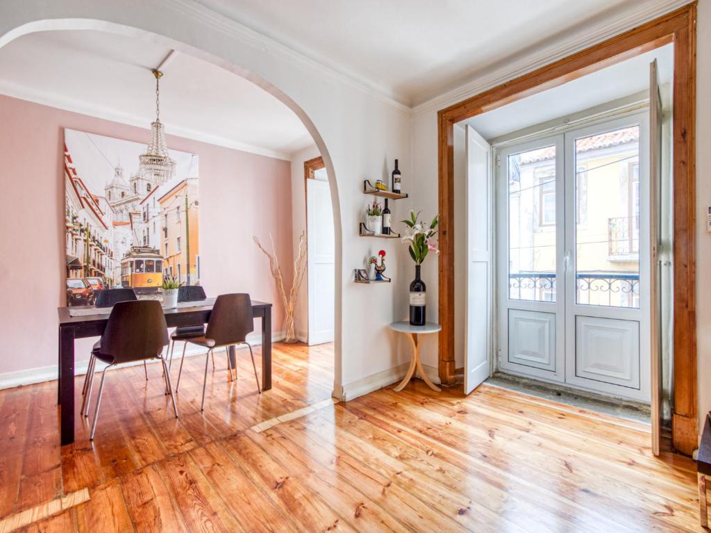 a living room with a table and chairs and a door at Apartment in the heart of Lisbon in Lisbon
