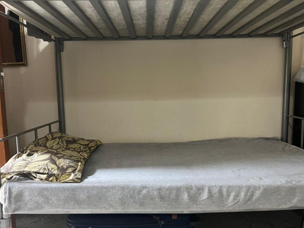 a bed in a room with a metal bed frame at Dormitory bed space in a shared room in Sharjah