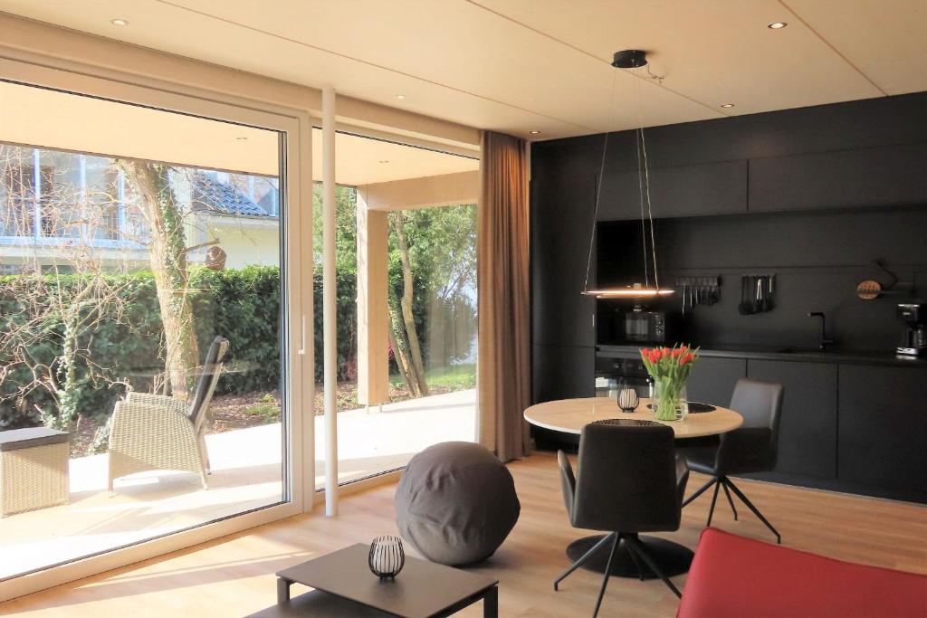 a living room with a table and a large window at Schatzkiste Schatzkiste 1 EG in Uhldingen-Mühlhofen