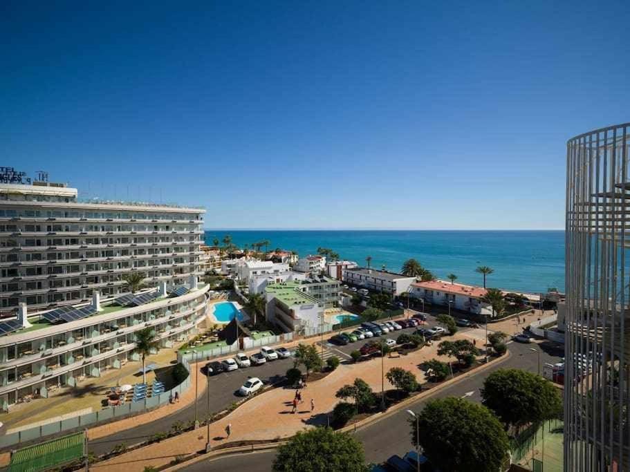 a view of a city with a building and the ocean at Marlenghi Apartments 412 in San Bartolomé