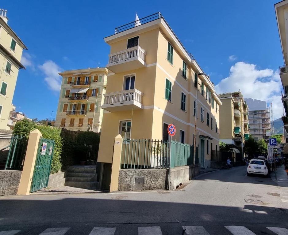 a yellow building on the side of a street at Affittacamere House LeoMar di Sara in Genoa