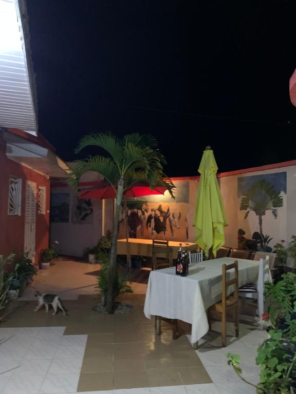 a patio with a table and a green umbrella at Homelidays in Ivato