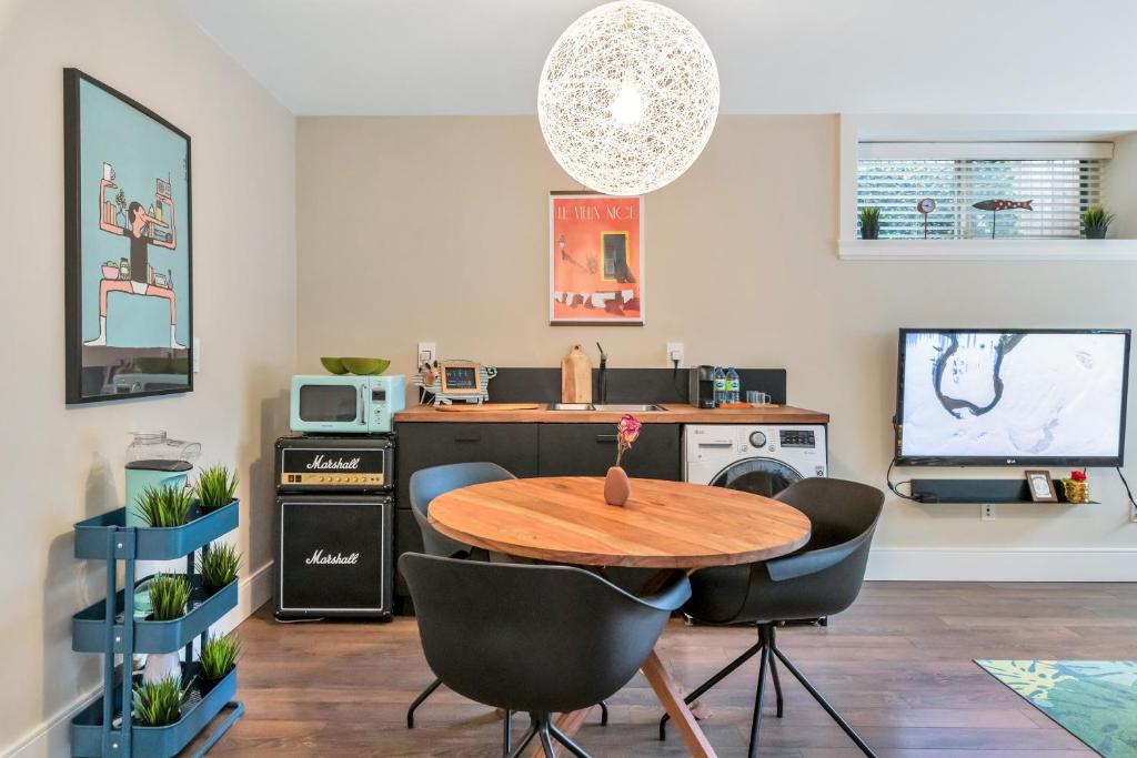a living room with a wooden table and chairs at Boutique in Vancouver