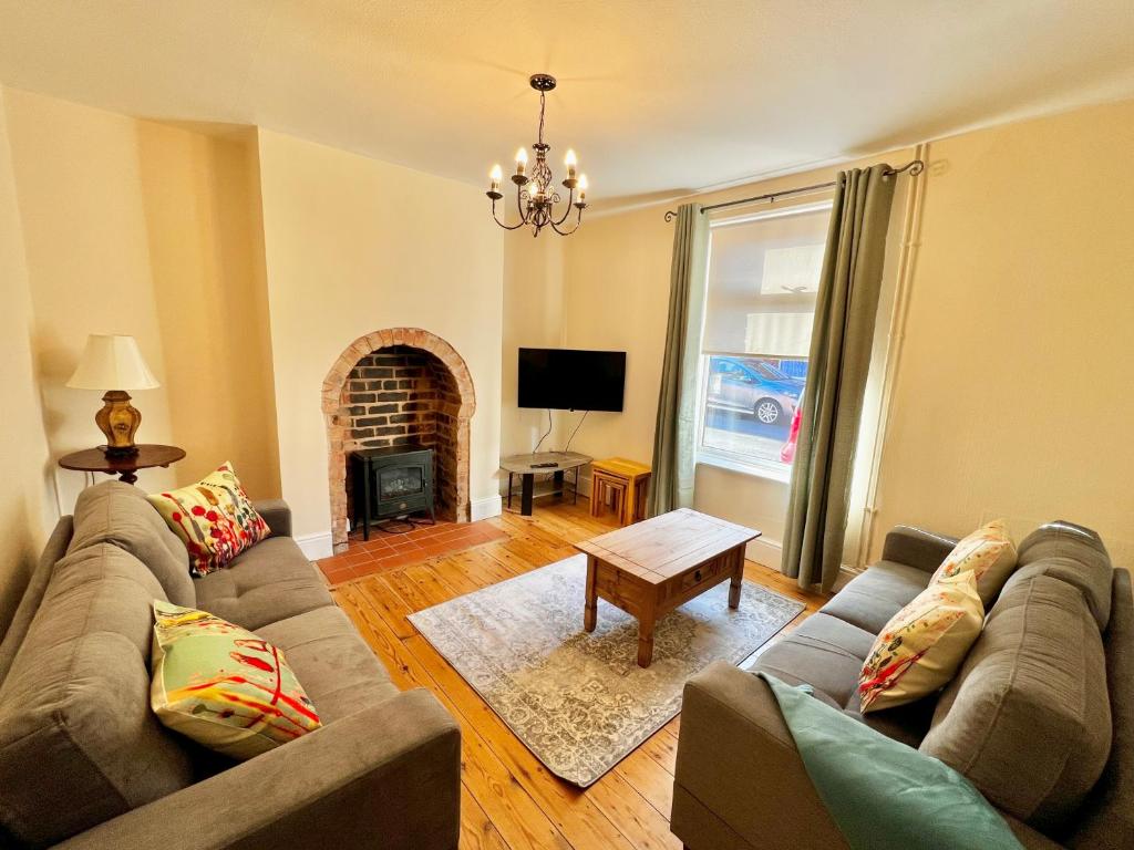 a living room with a couch and a fireplace at St Nicholas Street in Lincoln