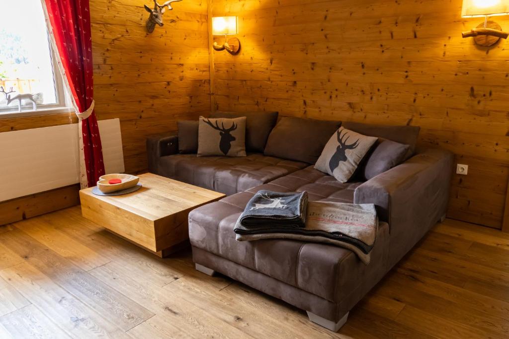 a living room with a couch and a coffee table at Appartement Tirolia Leutasch in Leutasch