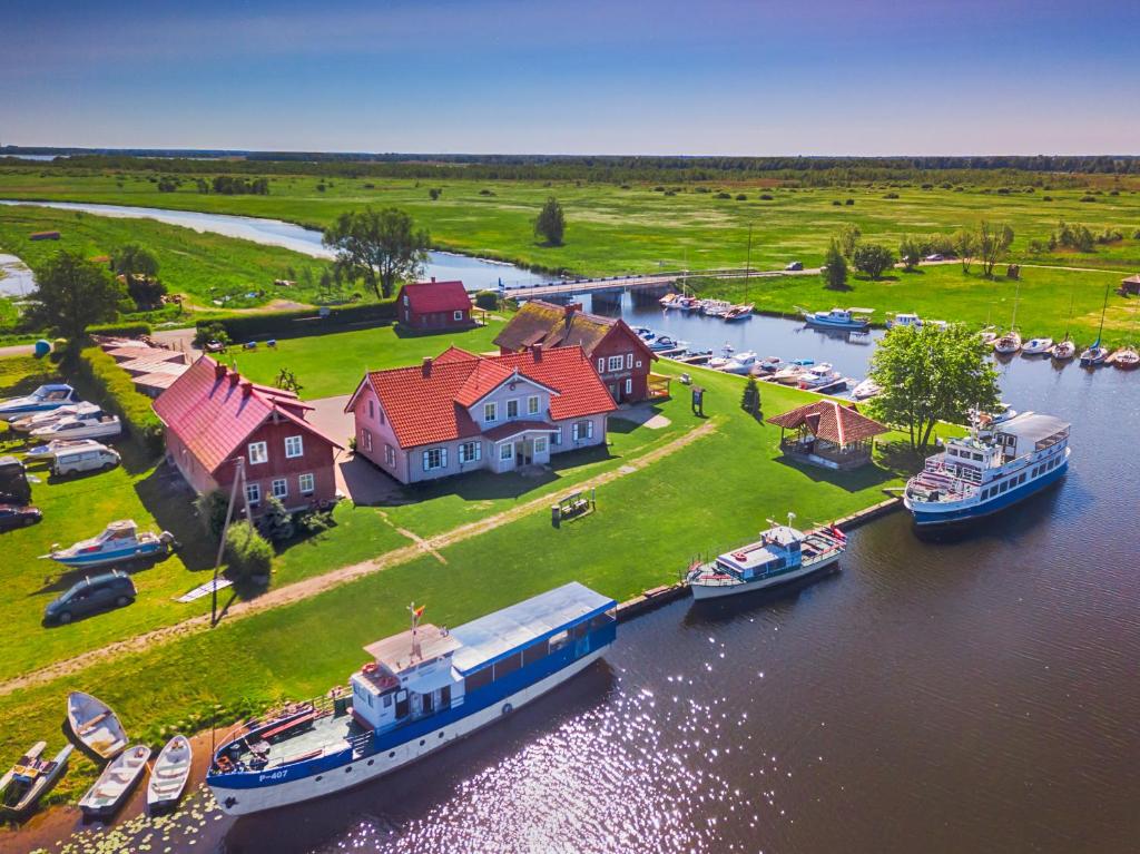 an aerial view of a house and boats in a river at Mingės Egzotika in Mingė